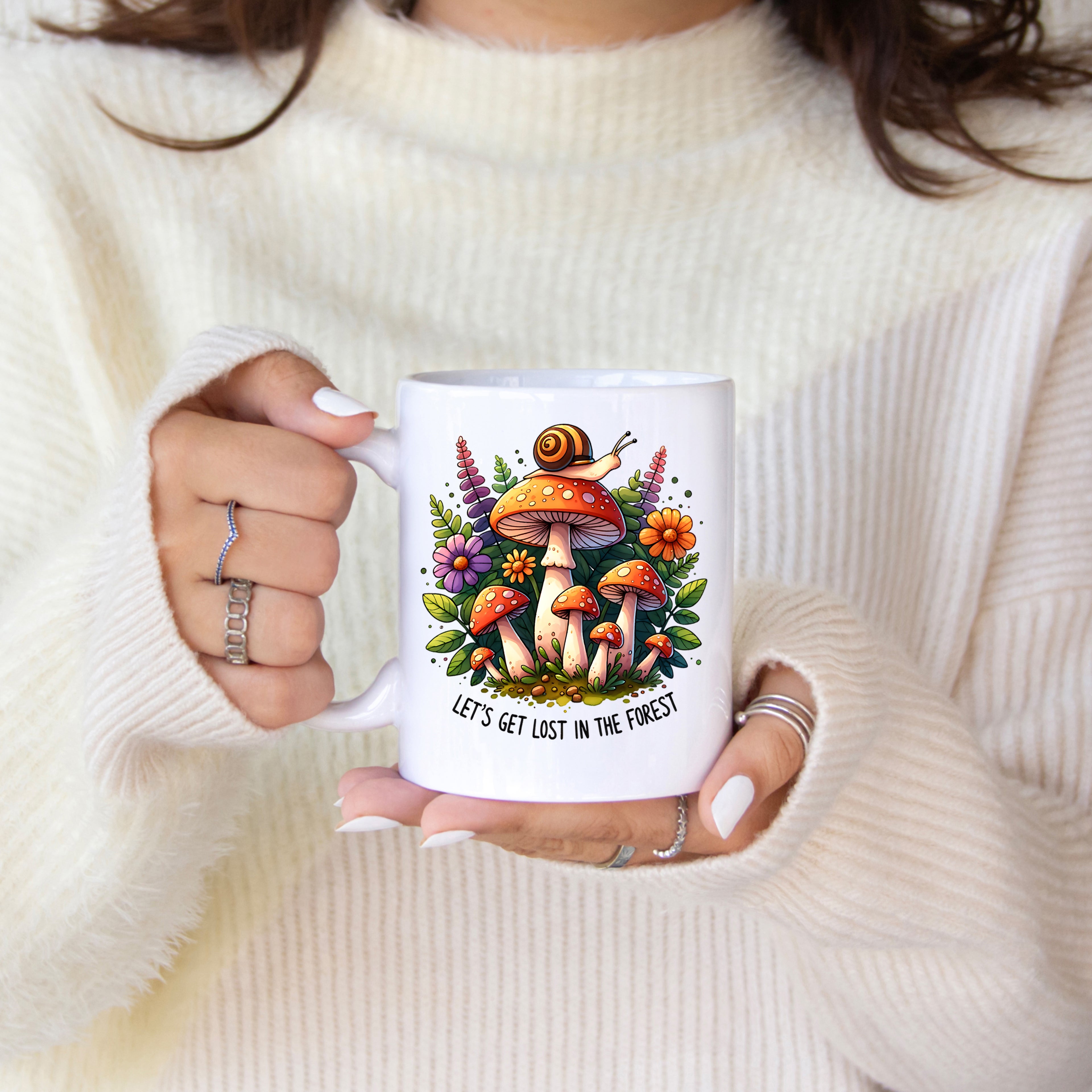 Person holding a mug with a forest-themed design and text