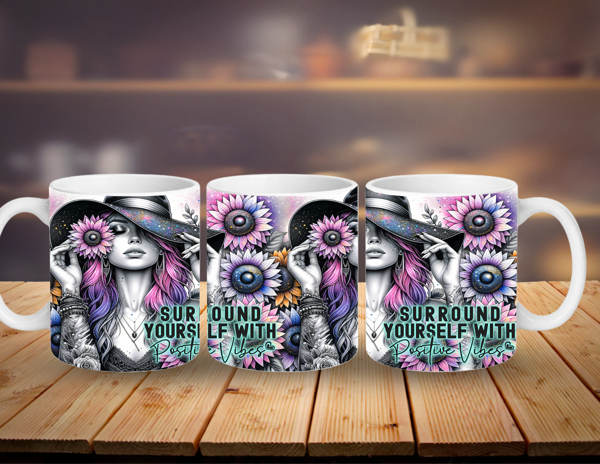 Three mugs with a design of a woman with flowers and text 'Surround Yourself with Positive Vibes' on a wooden surface.