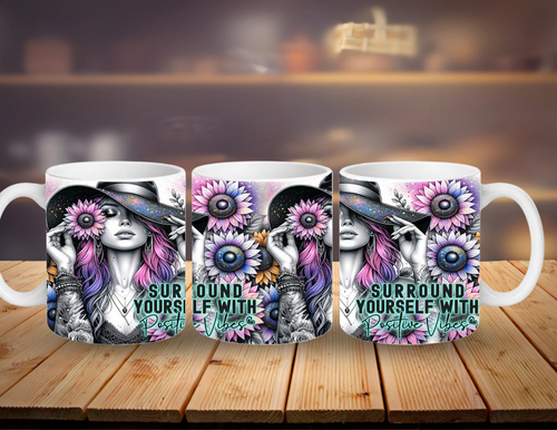 Three mugs with a design of a woman with flowers and text 'Surround Yourself with Positive Vibes' on a wooden surface.