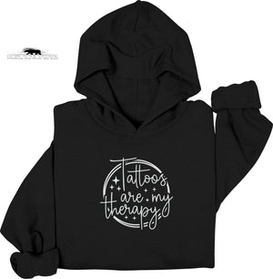 Black hoodie with 'Tattoos are my therapy' text on a white background