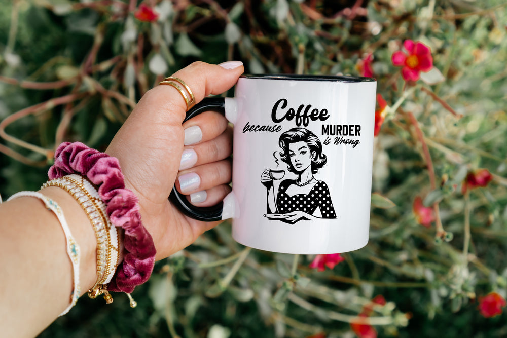 Hand holding a mug with a humorous design and text against a natural background