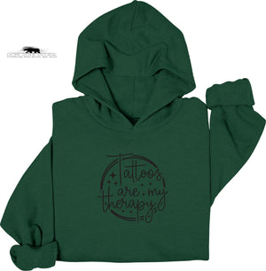 Green hoodie with 'Tattoos are my therapy' text on a white background