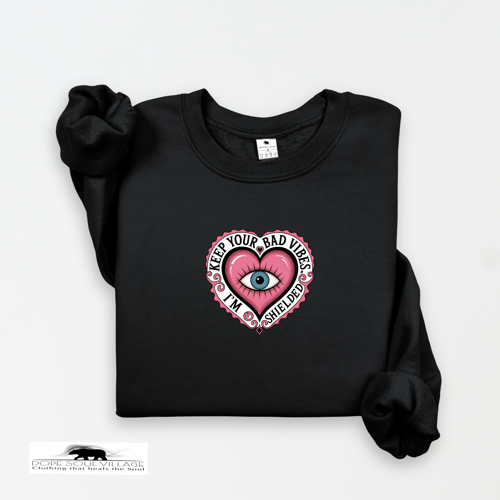 Black sweatshirt with a pink heart design featuring an eye and text on a white background