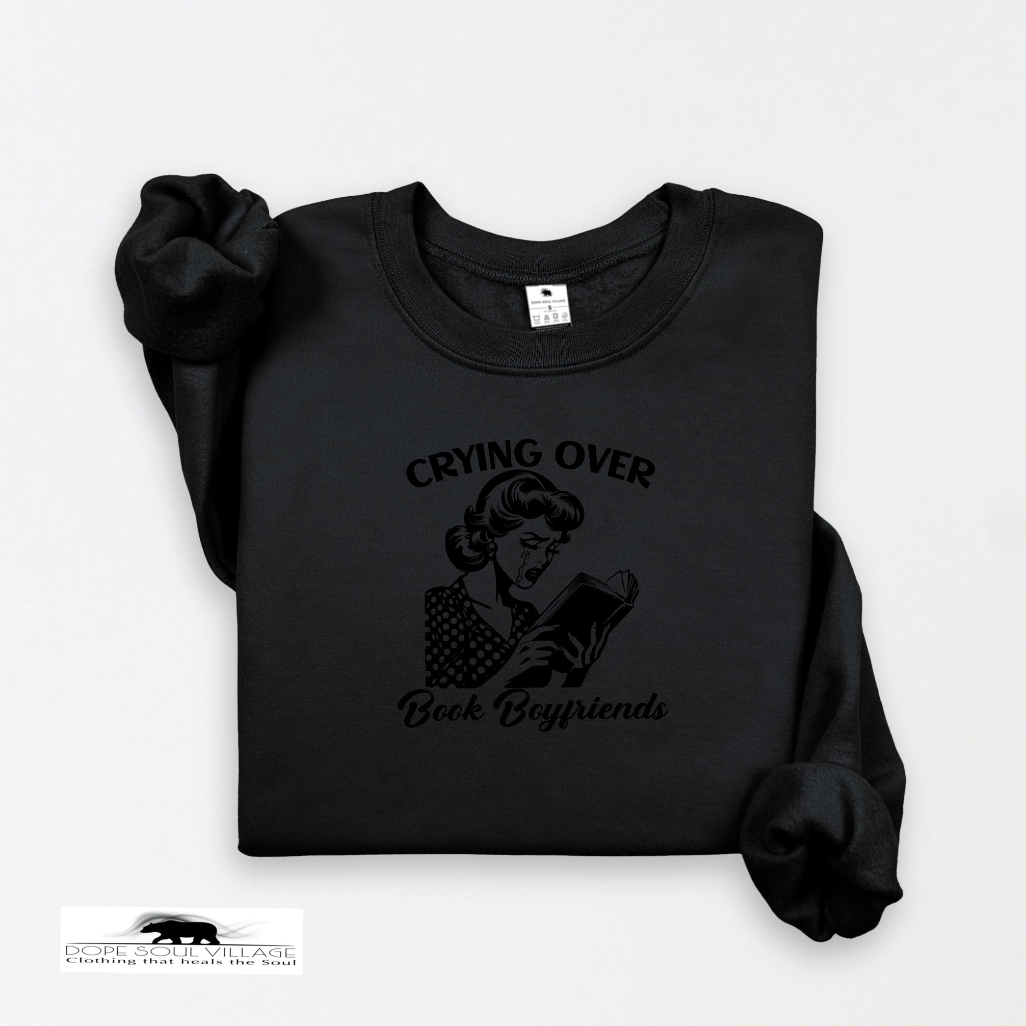 Black sweatshirt with graphic and text 'Crying Over Book Boyfriends' on a white background