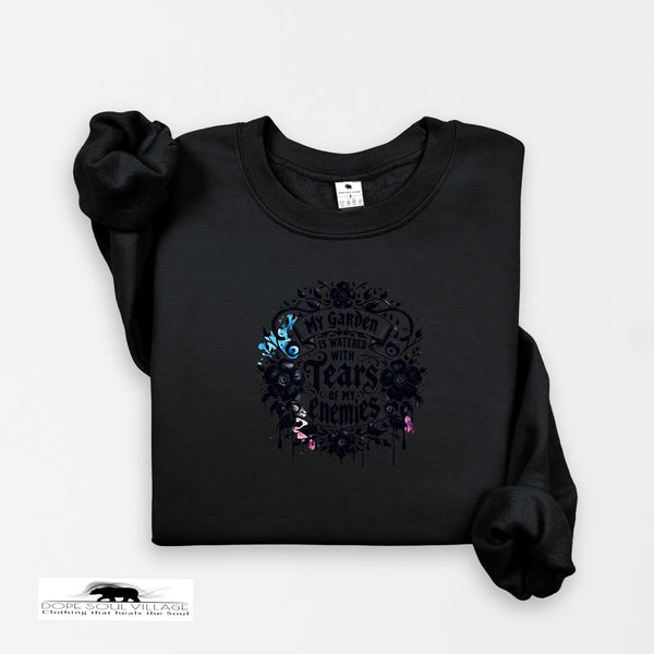 Black sweatshirt with floral design and text on a white background