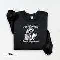 Black sweatshirt with graphic and text 'Crying Over Book Boyfriends' on a white background