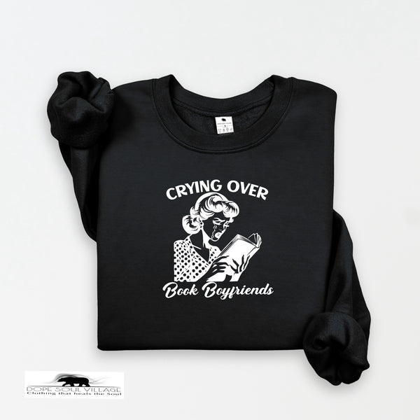 Black sweatshirt with graphic and text 'Crying Over Book Boyfriends' on a white background