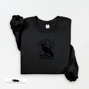 Black sweatshirt with a crow design and text on a white background