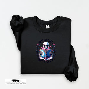 Black on black collection sweatshirt with a skull holding a book design on a white background dope soul village