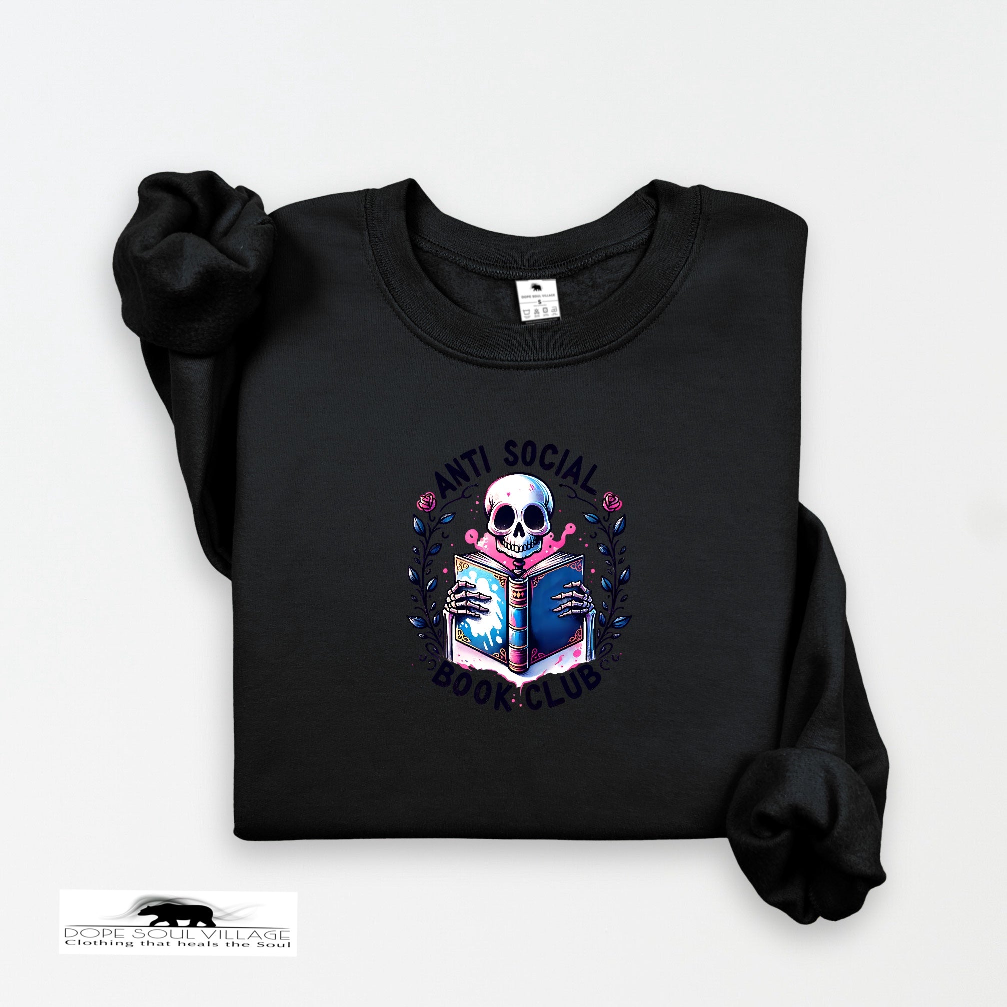 Black on black collection sweatshirt with a skull holding a book design on a white background dope soul village