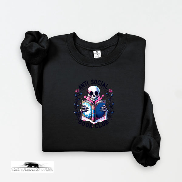 Black on black collection sweatshirt with a skull holding a book design on a white background dope soul village