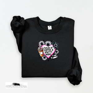 Black sweatshirt with a heart design featuring coffee and books on a white background