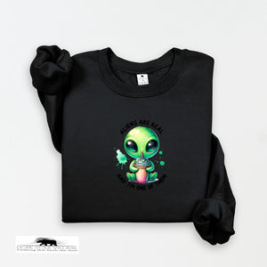 Black sweatshirt with a green alien graphic and text on a white background