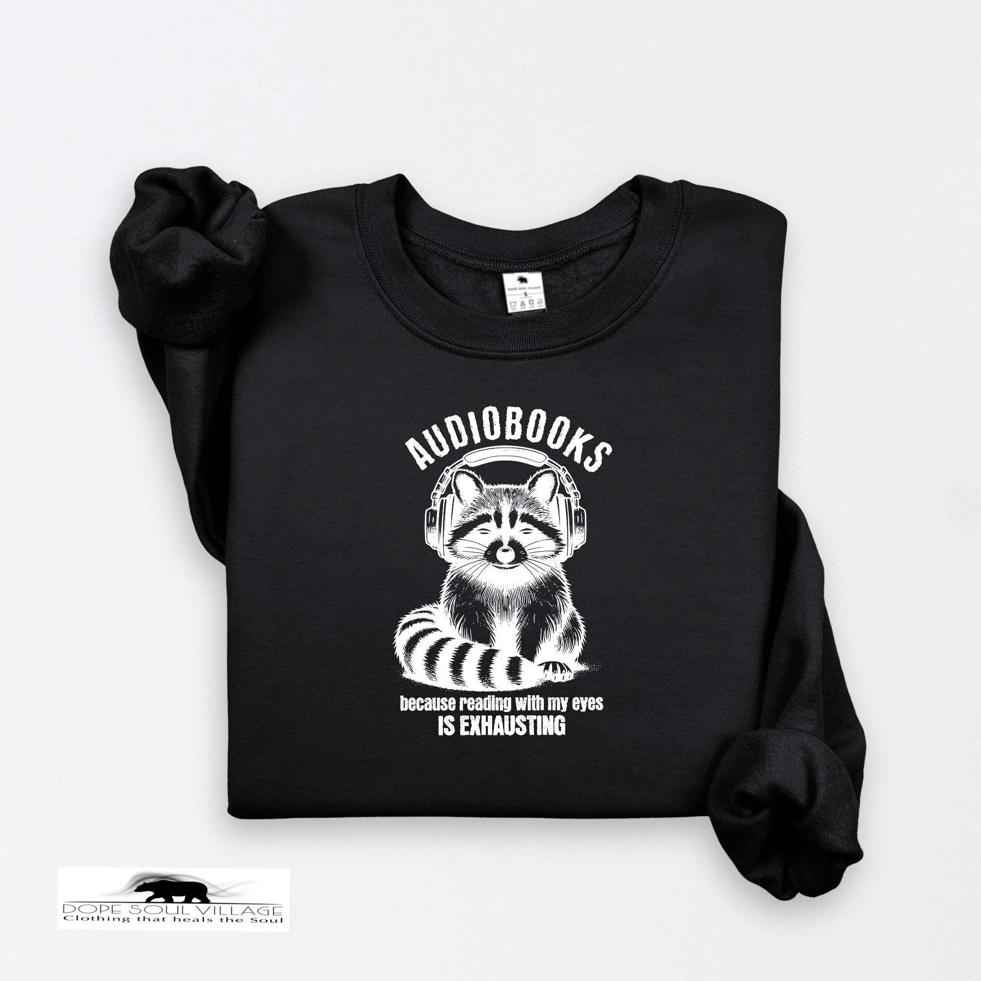 Black sweatshirt with raccoon graphic and text on a white background