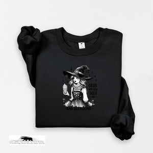 Black sweatshirt with a graphic of a witch and text on a white background