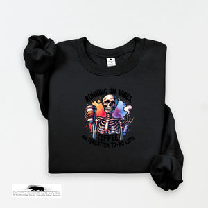Black sweatshirt with a colorful skeleton design and text on a white background