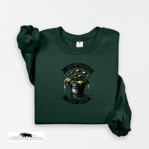 Dark green sweatshirt with a graphic design on a white background