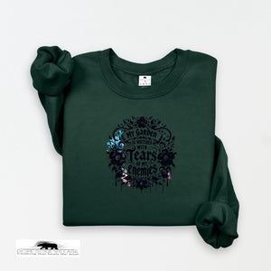 Dark green sweatshirt with floral design and text on a white background
