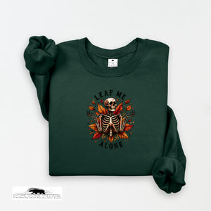 Green sweatshirt with a skeleton and leaf design on a white background