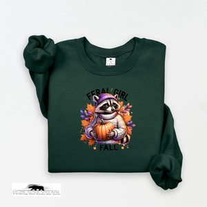 Green sweatshirt with a raccoon holding a pumpkin and 'Feral Girl Fall' text on a white background.