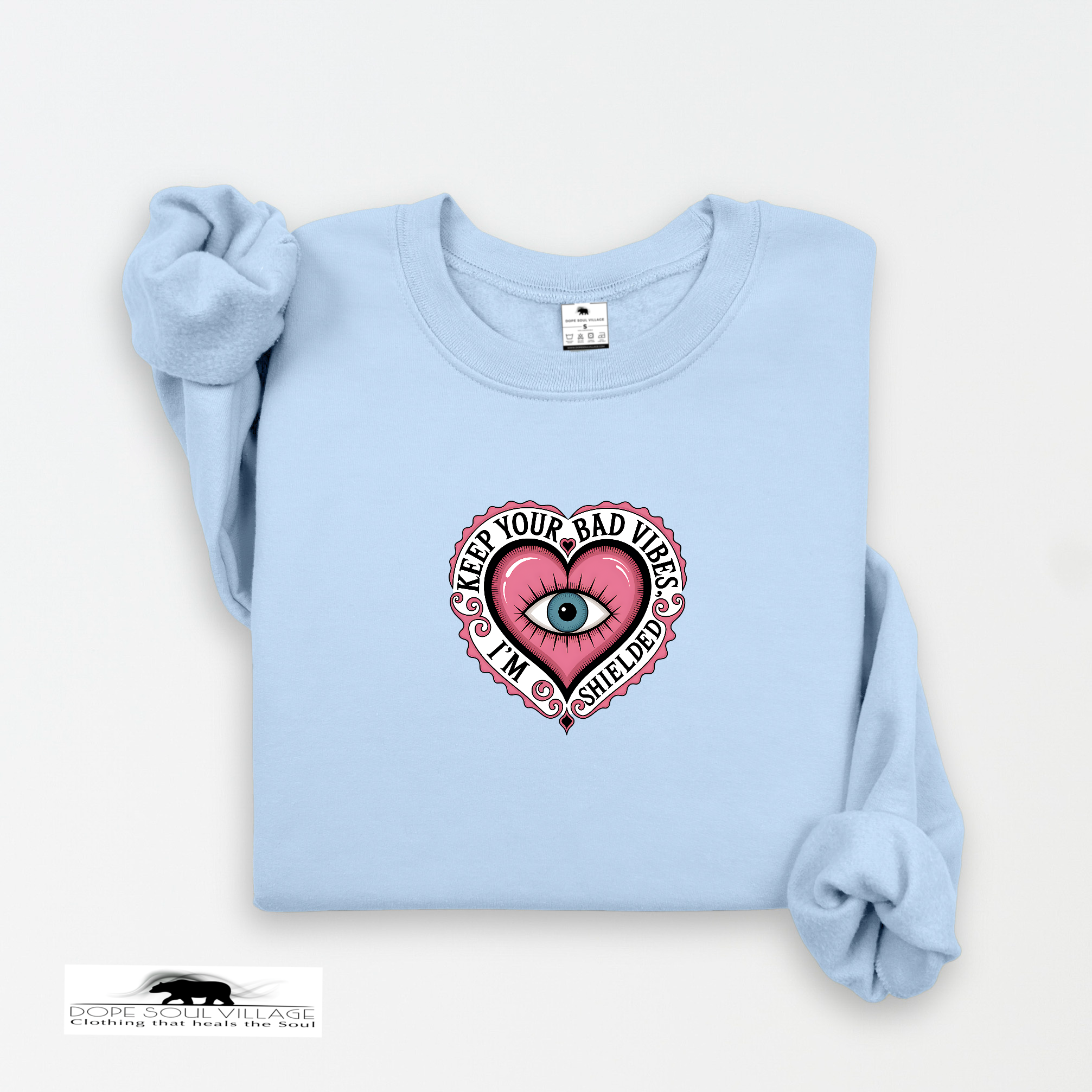 Light blue sweatshirt with a pink heart graphic and text on a white background