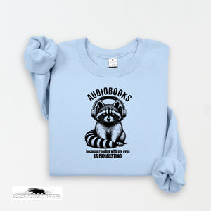 Light blue sweatshirt with raccoon graphic and text on a white background
