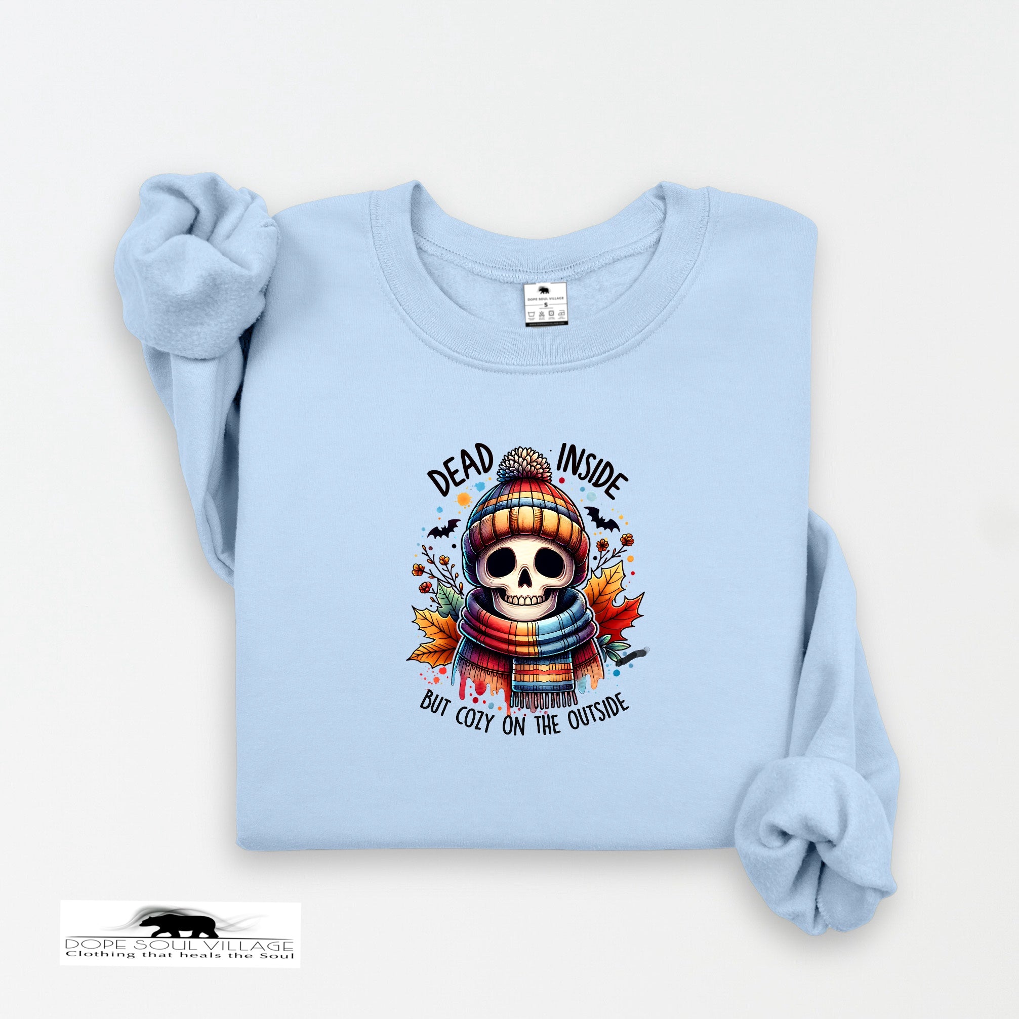 Light blue sweatshirt with a skull design and text on a white background