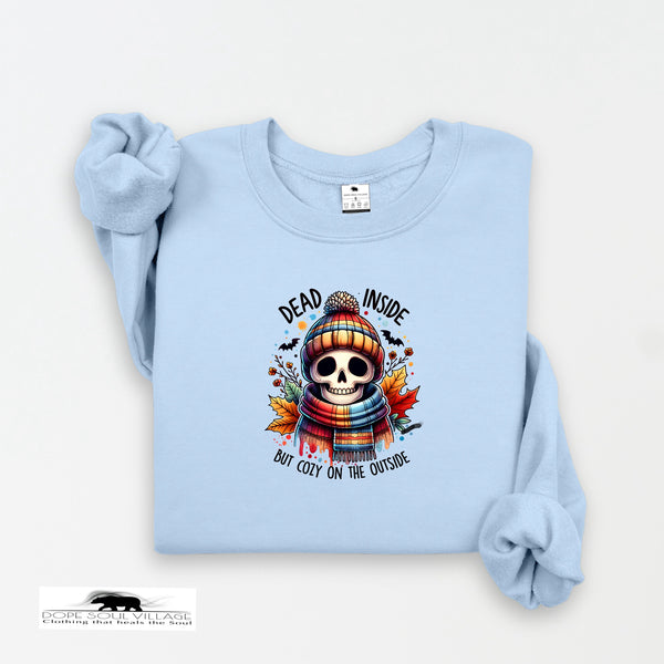 Light blue sweatshirt with a skull design and text on a white background