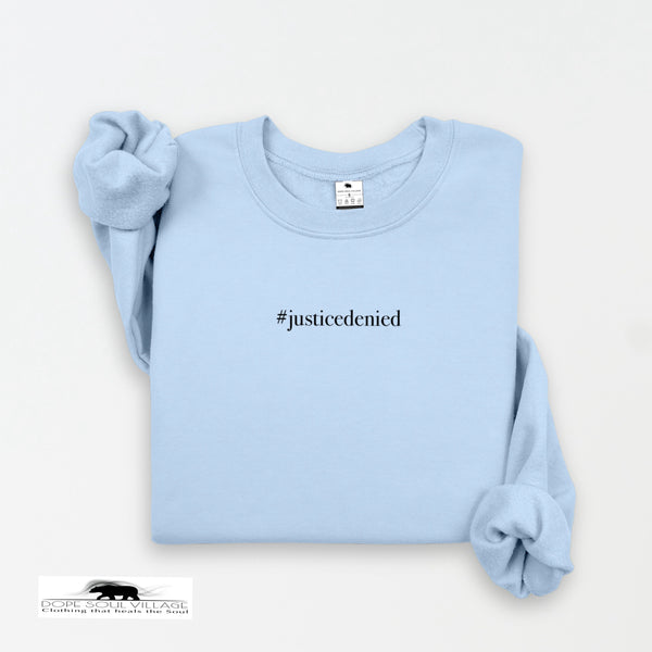 Light blue sweatshirt with '#justicedenied' text on a white background rebecca goodwin