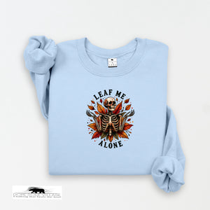 Light blue sweatshirt with skeleton and leaf design on a white background