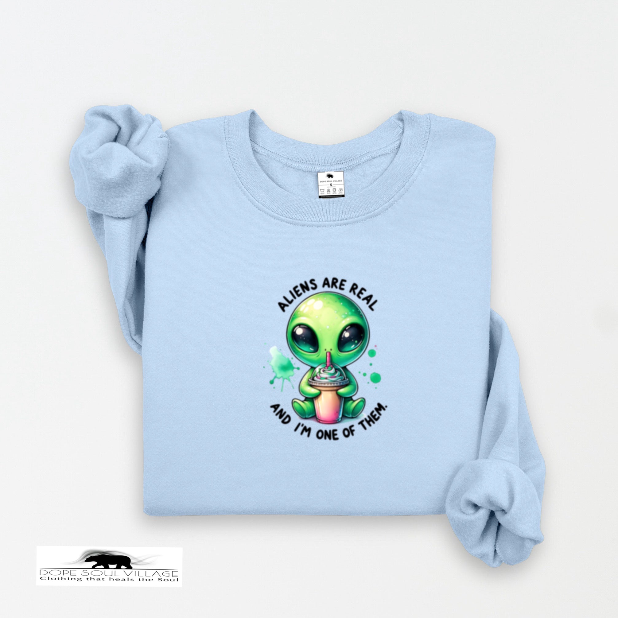 Light blue sweatshirt with a cartoon alien design and text on a white background