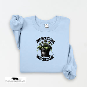 Light blue sweatshirt with graphic design and text on a white background