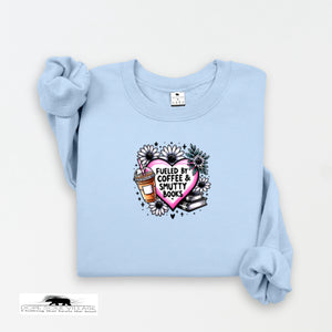 Light blue sweatshirt with a graphic design featuring a heart, coffee cup, and books on a white background.