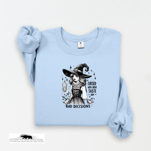 Light blue sweatshirt with a graphic of a witch and text on a white background