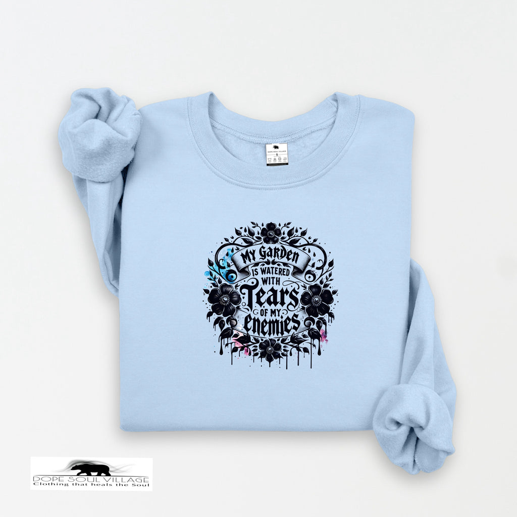Light blue sweatshirt with black floral design and text on a white background