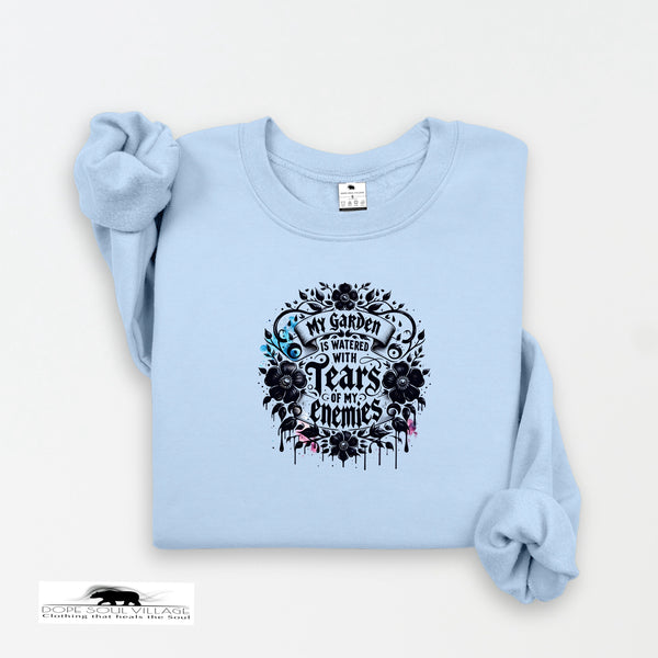 Light blue sweatshirt with black floral design and text on a white background