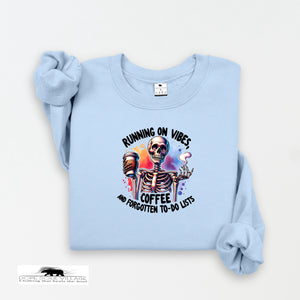 Light blue sweatshirt with skeleton design and text on a white background