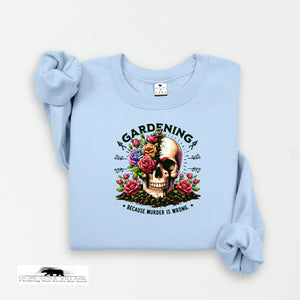 Light blue sweatshirt with a skull and floral design on a white background