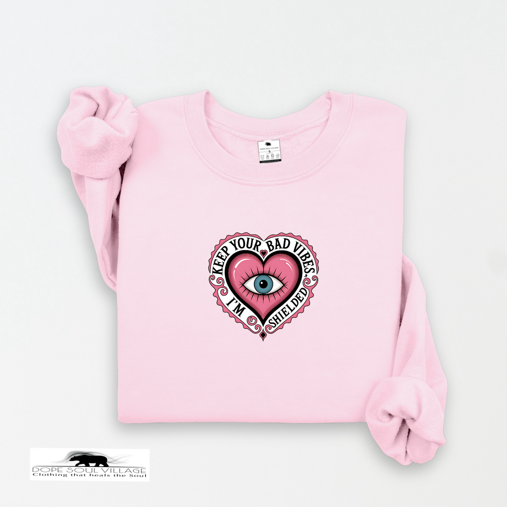 Pink sweatshirt with a graphic design on a white background