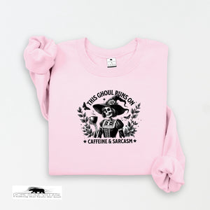 Pink sweatshirt with a graphic design and text on a white background