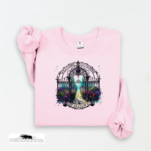 Pink sweatshirt with a decorative graphic on a white background