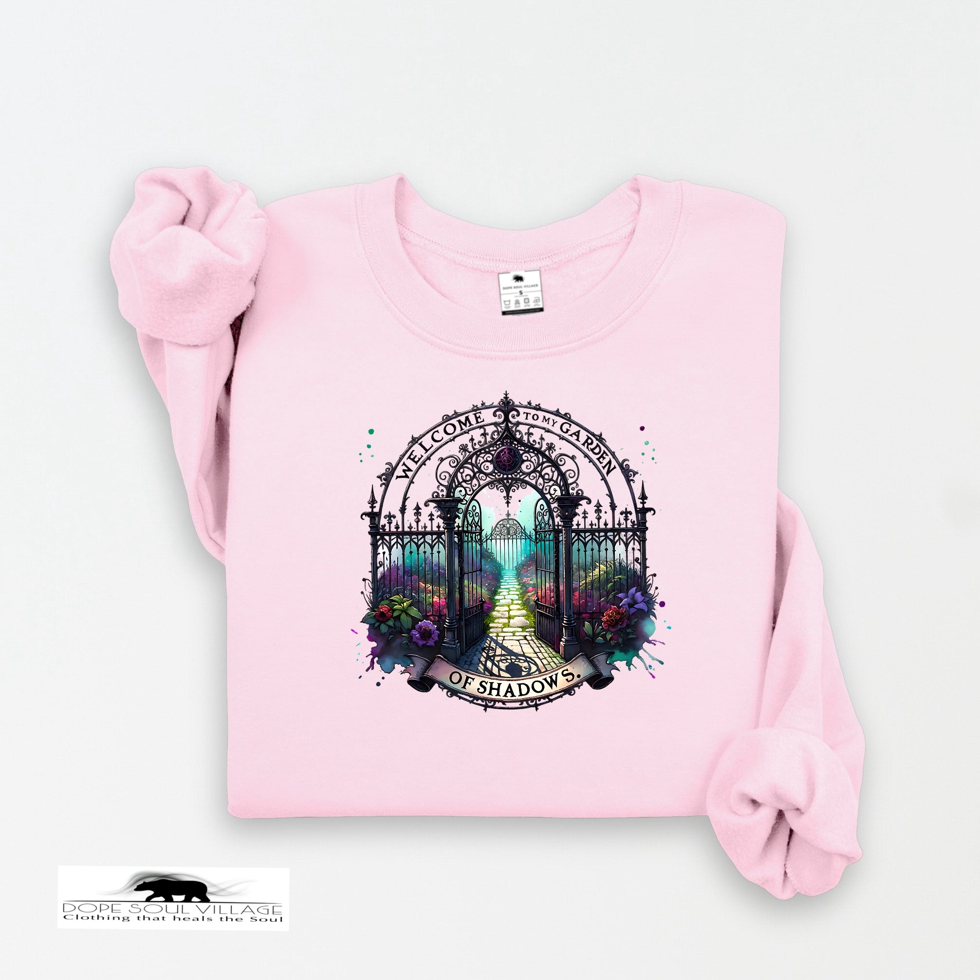 Pink sweatshirt with a decorative graphic on a white background