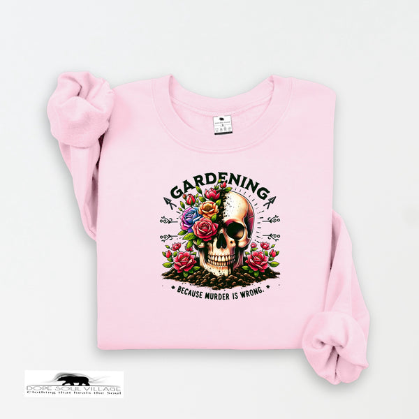 Pink sweatshirt with a skull design and text on a white background