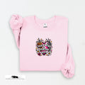 Pink sweatshirt with a graphic design on a white background