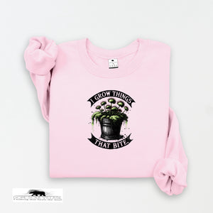 Pink sweatshirt with a graphic design and text on a white background