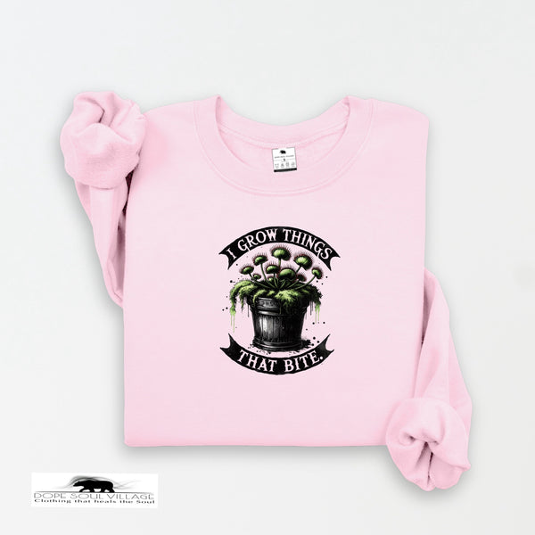 Pink sweatshirt with a graphic design and text on a white background