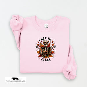 Pink sweatshirt with skeleton and leaf design on a white background