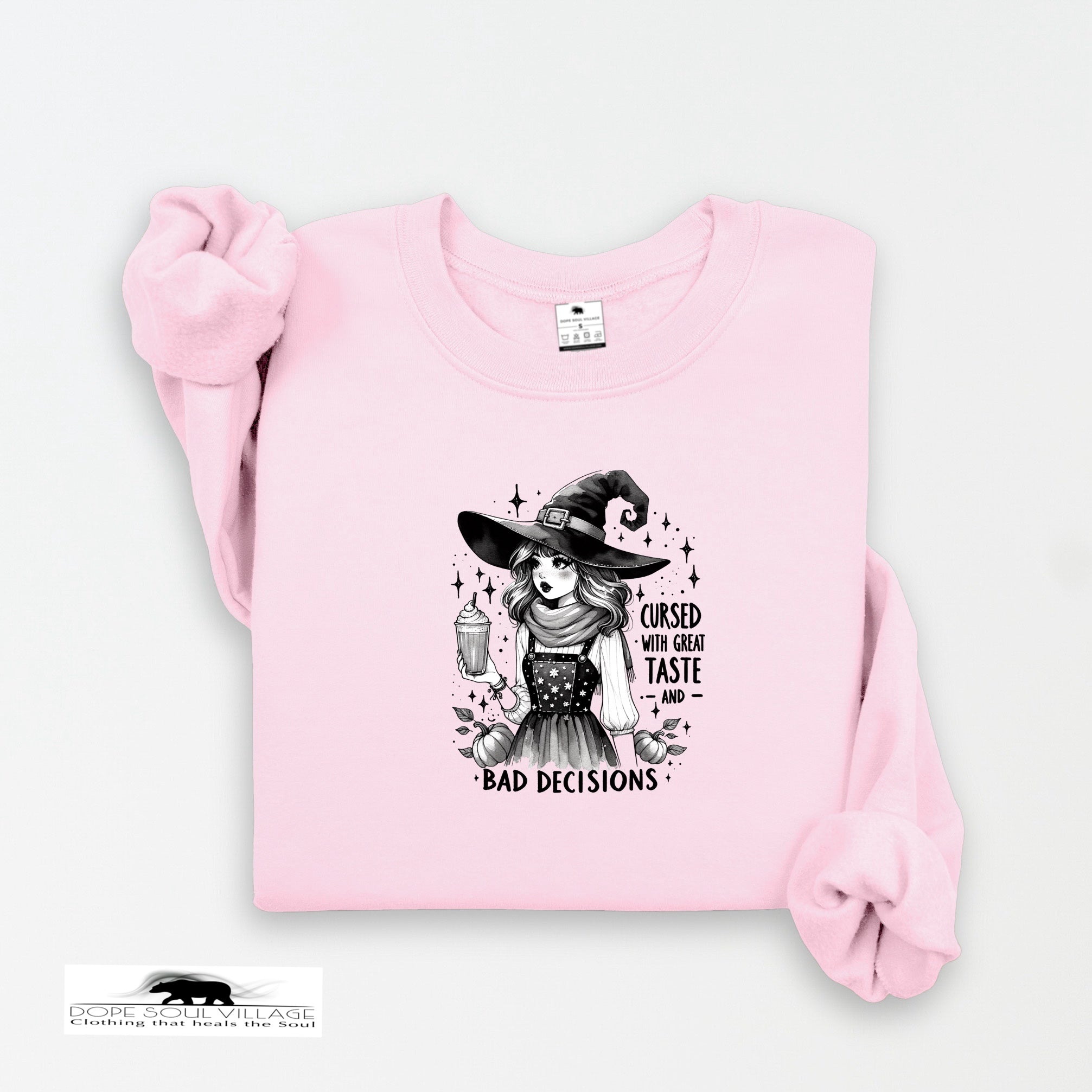 Pink sweatshirt with a witch graphic and text on a white background