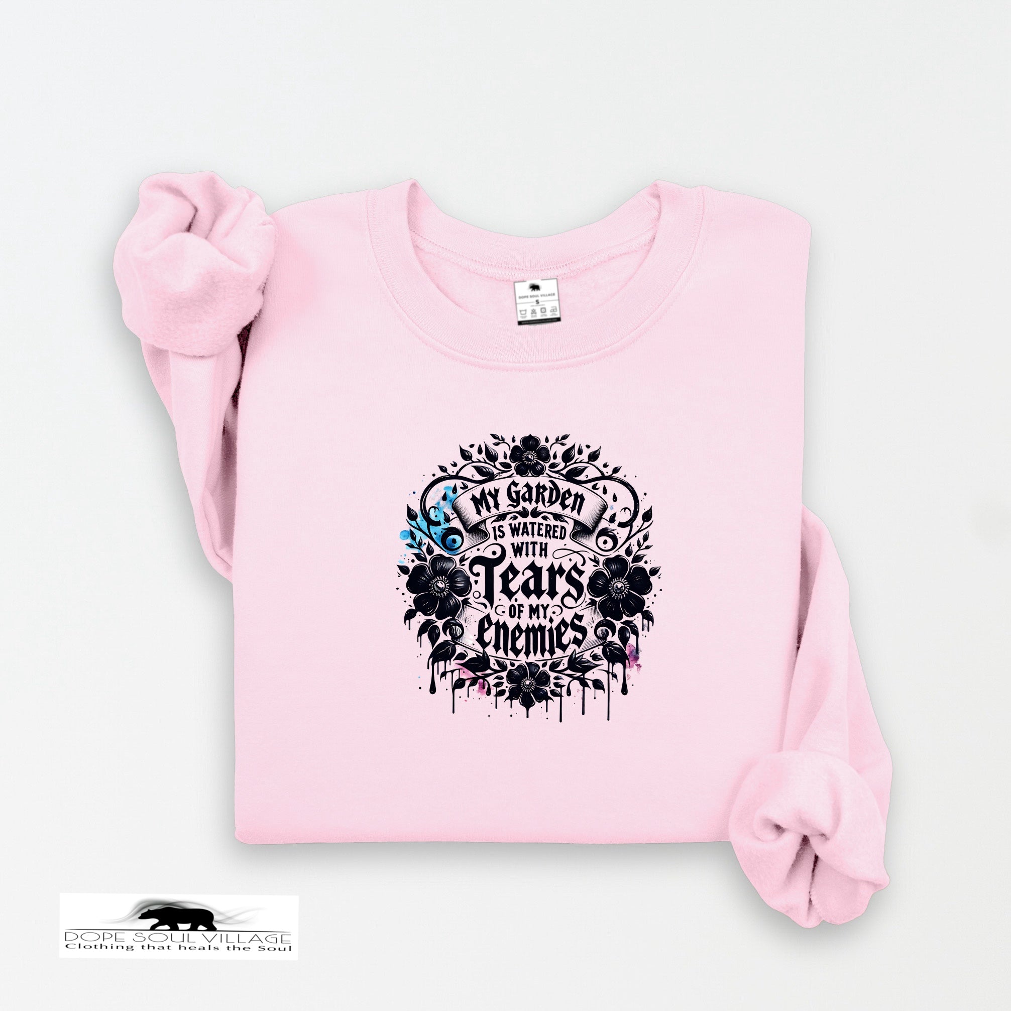 Pink sweatshirt with black graphic design on a white background