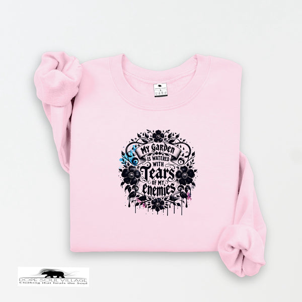Pink sweatshirt with black graphic design on a white background